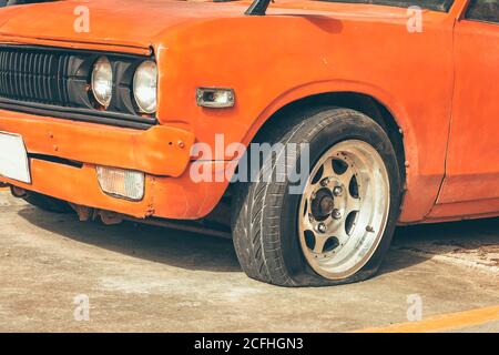 car wheel flat tire on the road in the city. Stock Photo