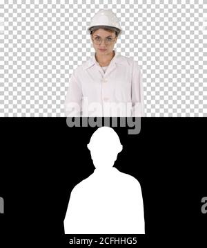 Young woman engineer in hard hat walking, Alpha Channel Stock Photo