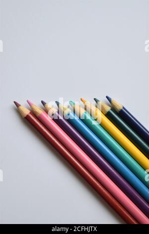 A neat row of colored pencils on a white background with copy space Stock Photo