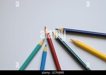 Sharp colored pencils arranged on a white background with copy space Stock Photo