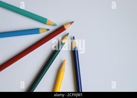Sharp colored pencils arranged on a white background with copy space Stock Photo