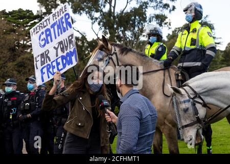 Melbourne, Australia, 5 September, 2020. A woman is interviewed by media flanked by mounted police during the Melbourne Freedom Protest, Phillip Island Circuit, Australia. Credit: Dave Hewison/Alamy Live News Stock Photo