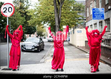 Red Maidens as part of Extinction Rebellion protest climate change in Cardiff Stock Photo