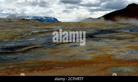 Geothermal valley Hverir in Iceland. At Namafjall Area many smoking fumaroles, boiling mud pots, surrounded by different colors sulphur crystals. Stock Photo