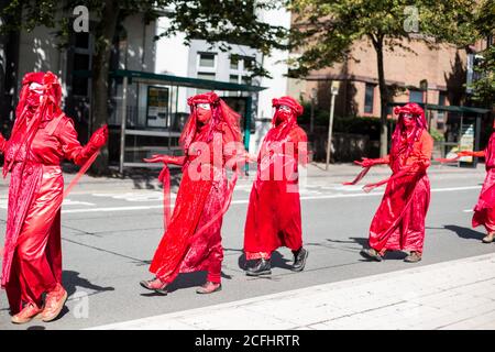 Red Maidens as part of Extinction Rebellion protest climate change in Cardiff Stock Photo