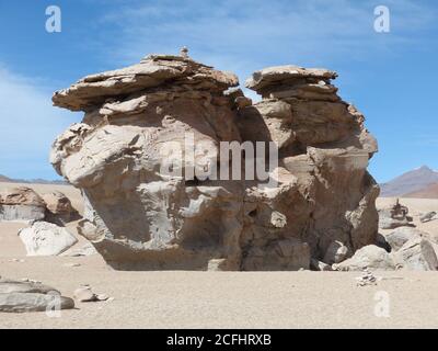 Giant rock formations in the arid desert Siloli, Altiplano plateau, Bolivia. Bizarre rock shape due to volcanic activity and wind erosion. Stock Photo