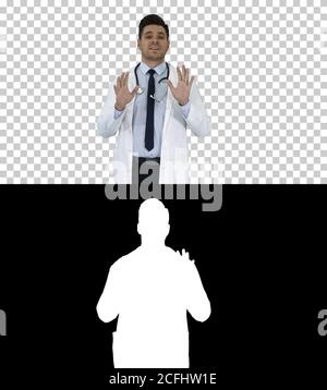 Friendly and playful male doctor and confident talking to camera, Alpha Channel Stock Photo