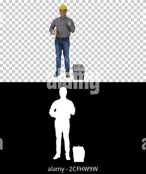 Young happy engineer worker in a helmet showing we did it gesture, Alpha Channel Stock Photo