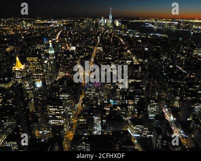 New York city at nightfall. Lights night city. Aerial view on the NYC, USA. Buildings. Skyscrapers. Impressive urban cityscape. Town illumination. Stock Photo