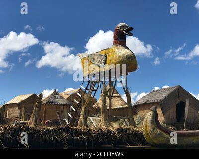 Scenic landscape of Uros Floating Island on peruvian side of Lake Titicaca, Peru. Uru people constructed Duck watch tower of the local totora reeds. Stock Photo