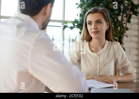 Young woman listening to doctor at medical appointment in hospital Stock Photo