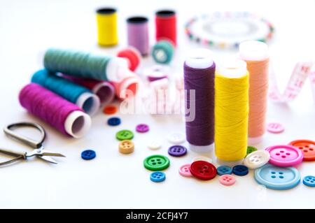 Color threads and sewing accessories on white background Stock Photo