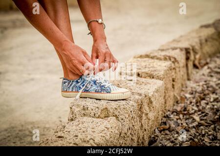 Close up of a woman tying her shoelaces Stock Photo
