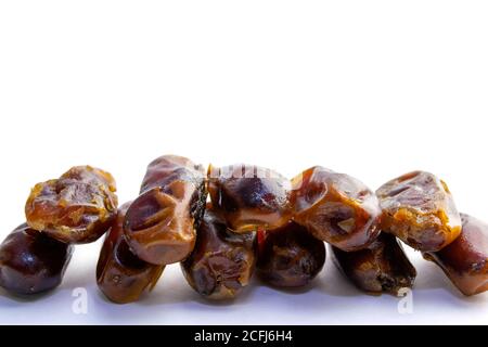 Sweet dry dates laid out in two rows, isolated on the white background. copy paste Stock Photo
