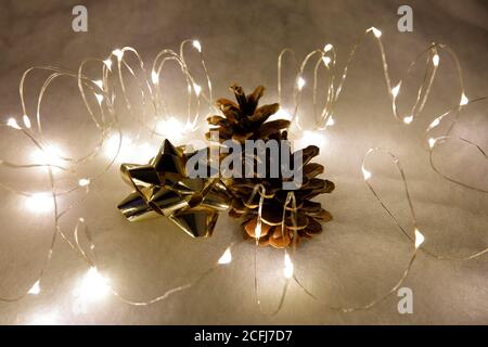 Pine cones, a star loop and fairy lights for Christmas time Stock Photo