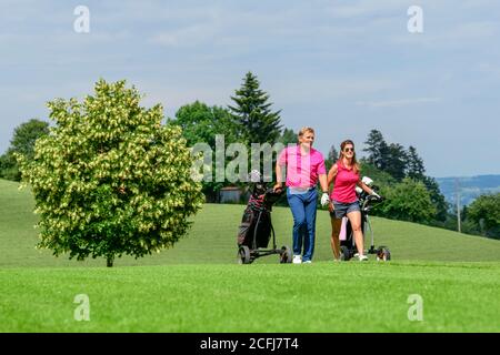 Couple on the way on golf course Stock Photo
