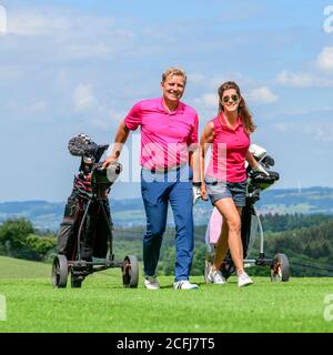 Couple on the way on golf course Stock Photo