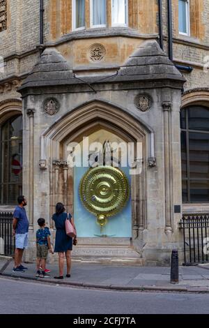 The Corpus Clock, also known as the Grasshopper clock, on the outside of Taylor Library at Corpus Christi College, Cambridge, Cambridgeshire, UK. Stock Photo