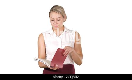 Woman in formal clothes opens notebooks and looks inside on white background. Stock Photo