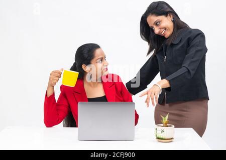 Two professional Indian women working on computer, work from home, Corporate employees holding video meeting with client, Stock Photo