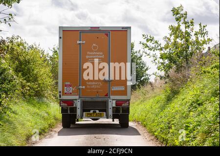 Denham, Buckinghamshire, UK. 4th September, 2020. A Sainsbury's delivery van squeezes down a country lane that has been closed by HS2 except for access. Construction work continues on the controversial HS2 High Speed Rail link from London to Birmingham off the A412 North Orbital. Huge swathes of the countryside have been bought by HS2 Ltd under  compulsory purchase orders. The controversial railway line puts 693 local wildlife sites and 108 ancient woodlands at risk of destruction along the path of the new railway. Felling of trees has already started in Denham. Credit: Maureen McLean/Alamy Stock Photo