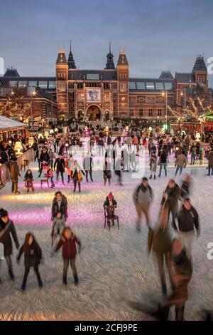 The Netherlands, Amsterdam, Museum square. Artificial ice skating rink in front of Rijksmuseum. Winter. Stock Photo