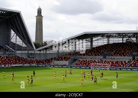 General view of the action on the pitch in front of empty stands during the Carabao Cup first round match at Brentford Community Stadium, Brentford. Stock Photo