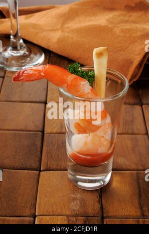 Shrimp prawns in a shot glass with cocktail sauce Stock Photo