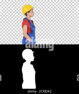 Construction worker lady walking emotionless, Alpha Channel Stock Photo