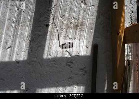 Old cracked wall with a window shadow on it Stock Photo