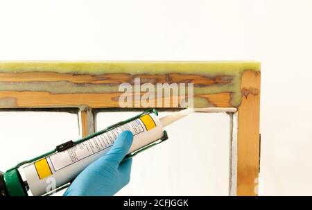 Close up of a person applying dry seal to restored sash windows. Stock Photo