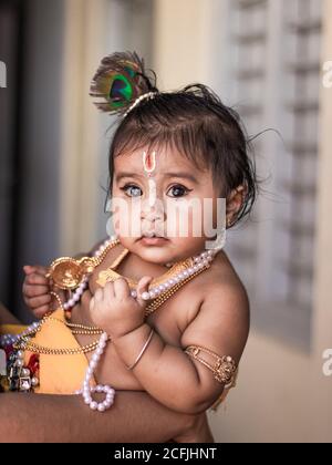 Cute baby dressed up like lord krishna/gopal in the occasion of janmashtami stock image. Stock Photo