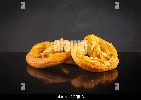 Homemade baked salt pretzel on dark background. Oktoberfest concept Stock Photo