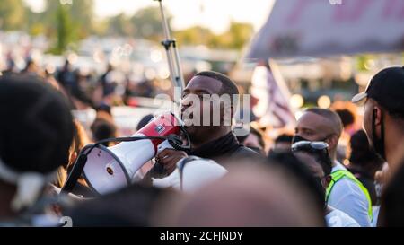 Louisville, United States. 05th Sep, 2020. A man addresses fellow protesters on a megaphone during the protests in demand for justice for Breonna Taylor.Anti-racism protesters marched around the perimeter of Churchill Downs on Kentucky Derby Day demanding justice for Breonna Taylor who was killed by the Louisville Metro Police over 100 days ago and no arrests have been made following her death. Credit: SOPA Images Limited/Alamy Live News Stock Photo