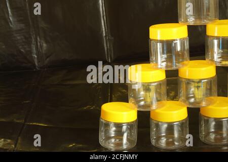 Empty jars ready for filling on a black background Stock Photo