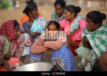 Market women wait for fish on the beach near the traditional fishing colony in Puri, Odisha, India Stock Photo