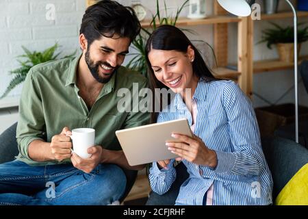 Close up portrait of an attractive married couple using digital tablet. Technology, people concept Stock Photo