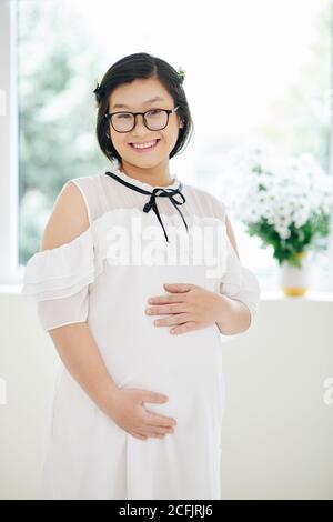 Smiling pregnant young woman Stock Photo