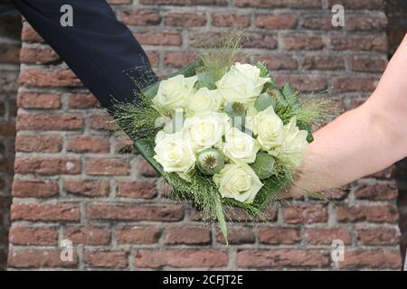 Closeup shot of a couple holding a bouquet of white rose on a wedding day Stock Photo