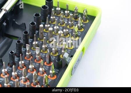 Sets of screwdriver metal bits isolated on white background. Tool set for household use. Nozzles and adapters for screwdrivers. Head different size he Stock Photo
