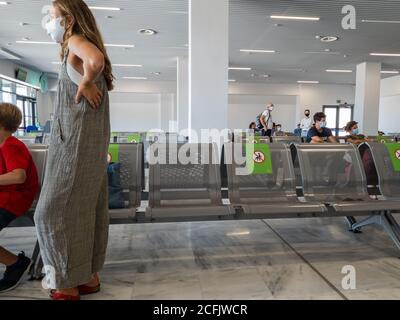 Holiday makers waiting for their return flight in the departure lounge of Aktion airport. Stock Photo