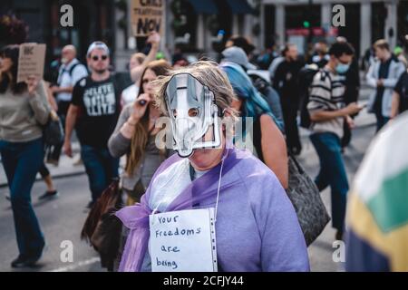 London / UK - 2020.09.05: Old lady wearing mask at Save Our Children Protest against Children Trafficking. Stock Photo
