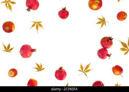 Pomegranate with apple and fall leaves isolated on white background. Flat lay, top view Stock Photo