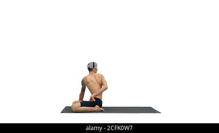 A young strong man doing yoga exercises stretches padmasana legs on white background. Stock Photo