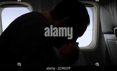 Airsickness. Man feels very bad on the plane. Stock Photo