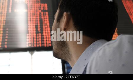 Business man checking on the board in the airport. Stock Photo