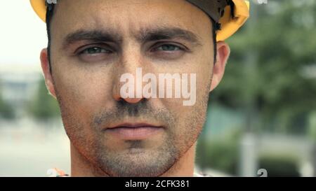Portrait of male industrial worker wearing helmet looking at cam Stock Photo