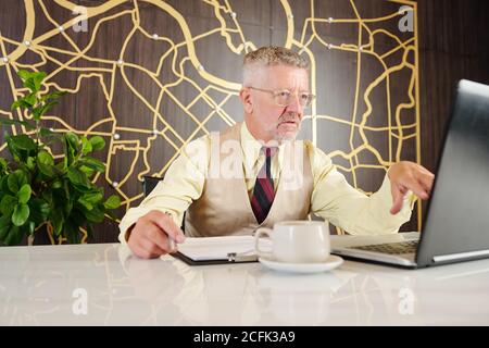 Serious businessman working on laptop Stock Photo