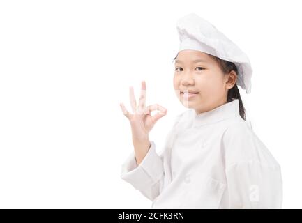 Happy asian girl chef in uniform showing OK sign  isolated on white background, Presenting your product concept Stock Photo