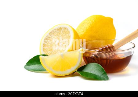 Fresh lemon with leaf and honey with honey dipper isolated on white background, ingredient summer beverage concept Stock Photo